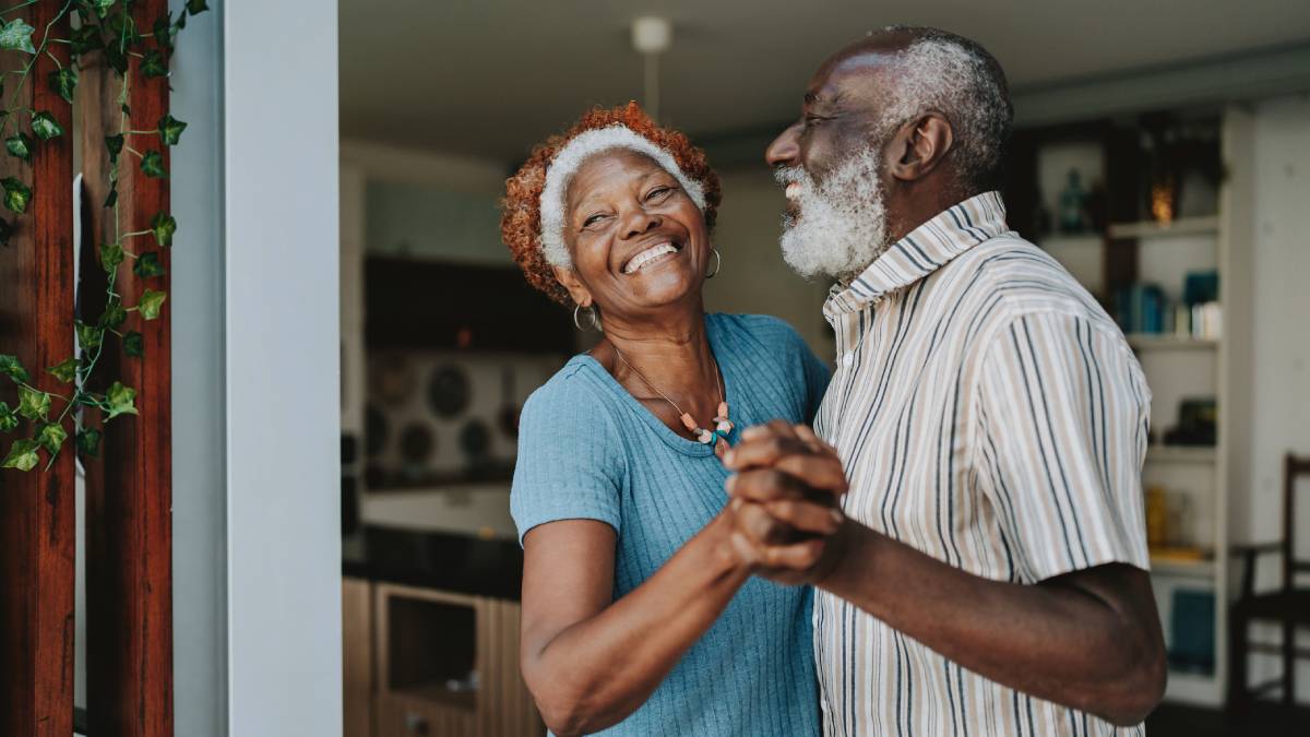 Happy couple dancing in kitchen